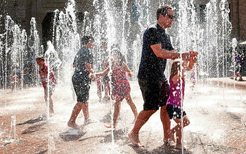 People walking through sprinklers