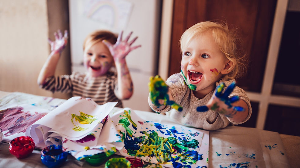 Two children playing with paint
