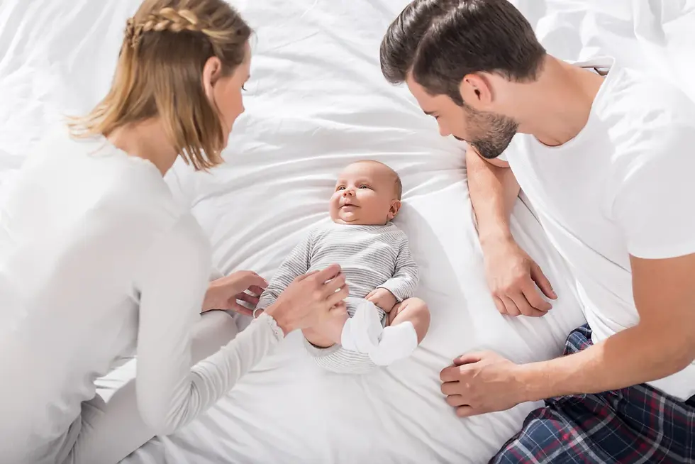 Parents watch over their baby