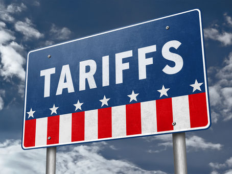 Blue political sign reading TARIFFS in white, with stars and red-white stripes against a cloudy sky.